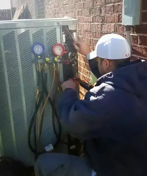 One of our skilled technicians checks a customer's air conditioner